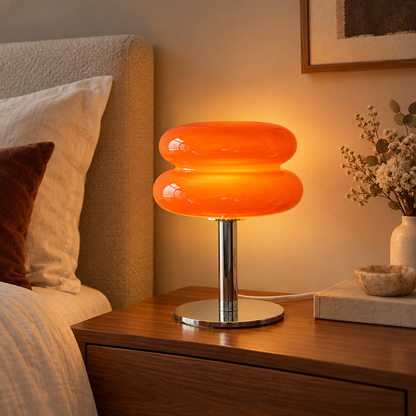 Italian designer glass table lamp on a bedside table