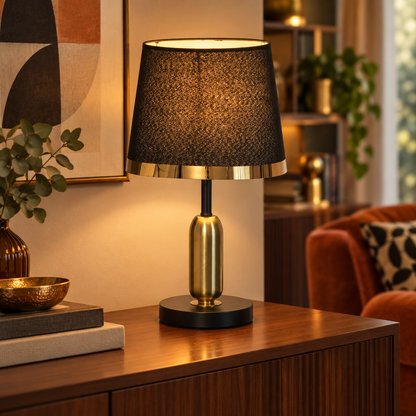 Vintage black and gold table lamp on a sideboard